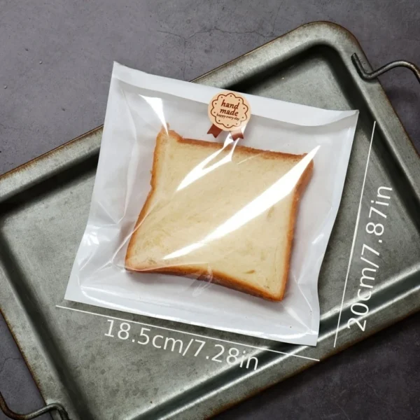 a0478264-34ed-11ef-89de-0a580a6610a4.webp 100pcs Clear Plastic Half-Wrap Bread Bags with Kraft Paper Stickers (18.3X20CM)